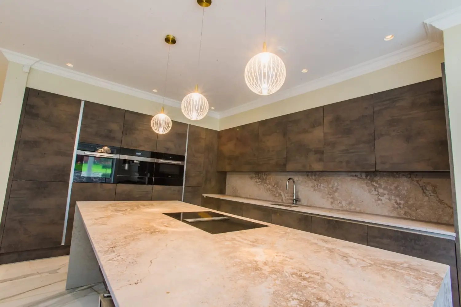 Modern open-plan kitchen featuring a circular ceiling light, marble flooring, beige designed by Rajvar Technologies.